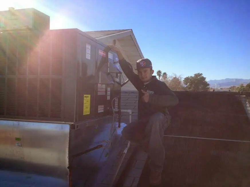 HVAC technician performing HVAC Inspection on a rooftop unit in Cheltenham